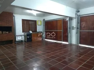 Foto de um ambiente interno com piso de ladrilhos terrosos e portas de madeira.
