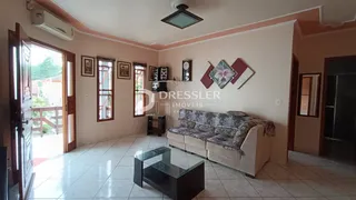 Sala de estar com sofá e piso de cerâmica em uma residência.