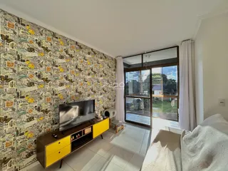 Sala de estar com parede de papel de parede com tema de jornal.