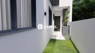 Foto da fachada de uma residência moderna em Lajeado, mostrando a entrada e o jardim.