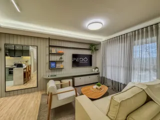 Sala de estar com sofá e decoração moderna em imóvel no Brasil.