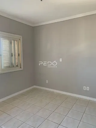 Ambiente interno de uma sala com piso de cerâmica clara.