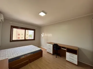 Quarto com cama e escrivaninha em um apartamento no Brasil.