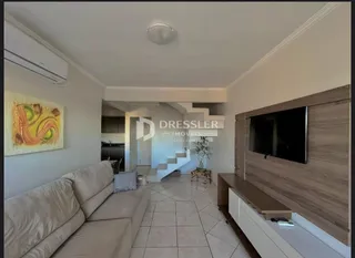 Sala de estar com sofá e parede decorada em um imóvel no Brasil.
