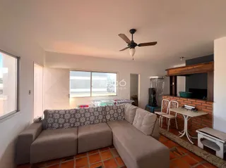 Sala de estar com sofá e piso de cerâmica na residência.