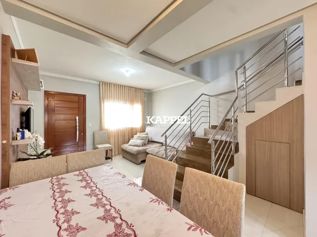 Quarto com cama grande e cortinas claras em ambiente interno.