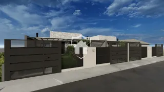 Fachada de uma residência em Lajeado, Brasil, com muro e paisagismo.