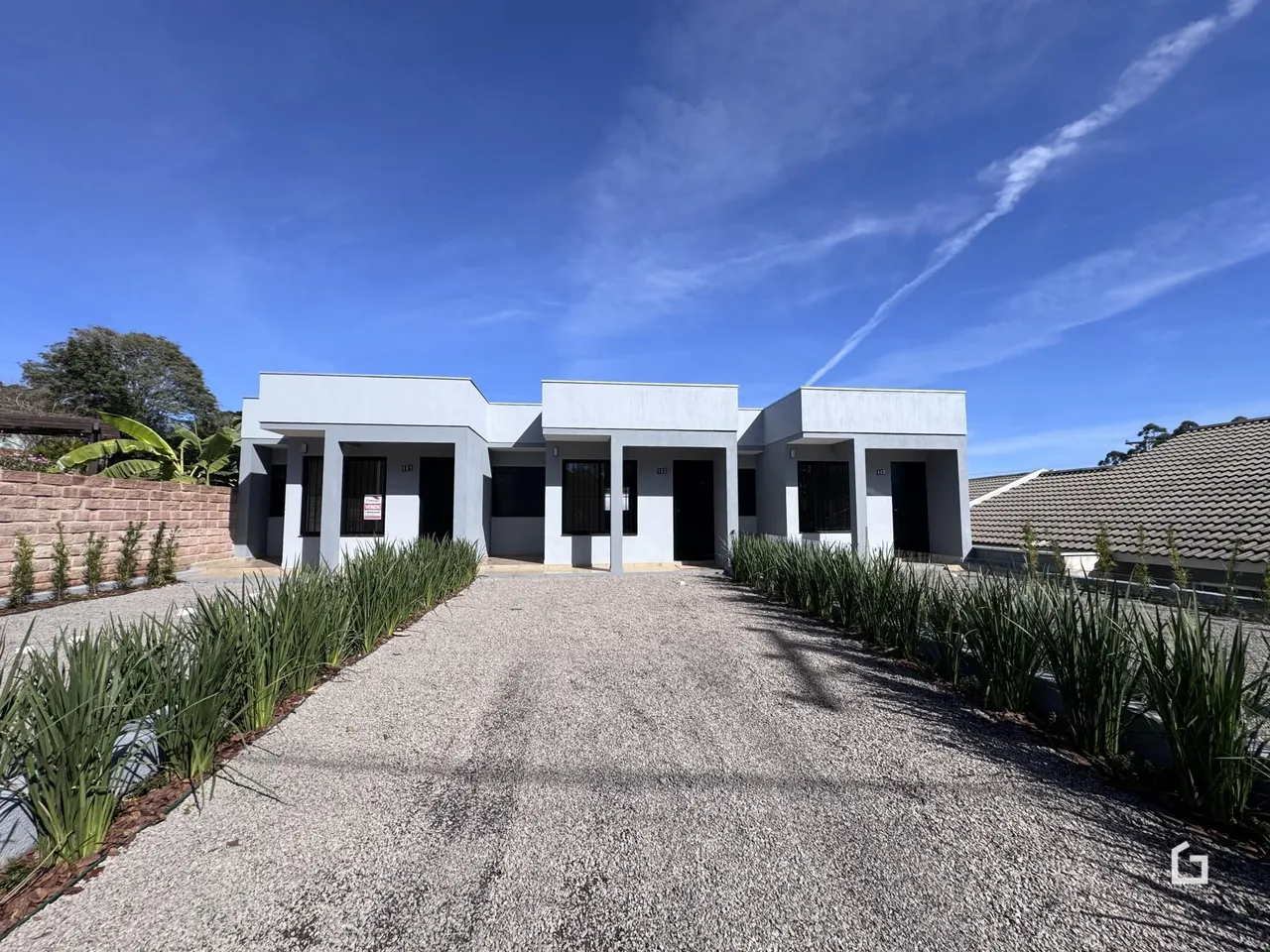 Fachada de uma residência moderna em Lajeado, Brasil, com jardim frontal.