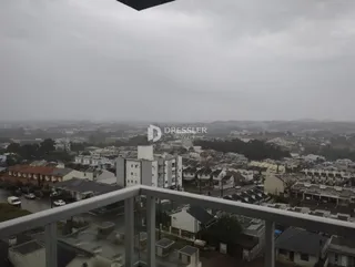 Vista aérea de uma área residencial em Lajeado, Brasil, com casas e ruas.