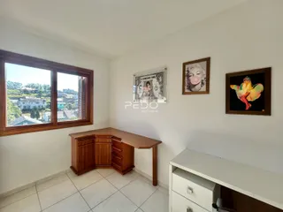 Ambiente interno com janela de grande porte e piso de cerâmica.