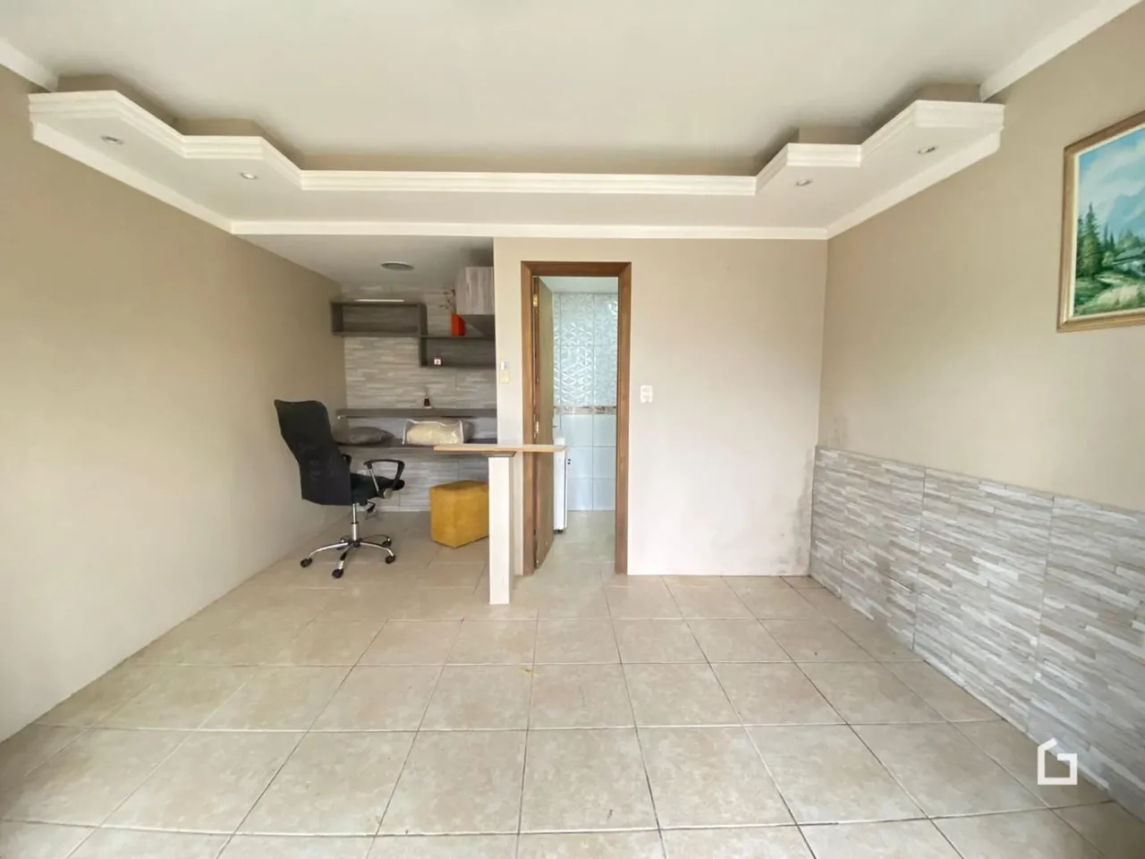 Vista de um corredor interno com piso de cerâmica claro.