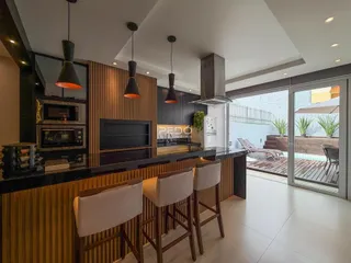 Vista da cozinha moderna com ilha e área de jantar em Lajeado.