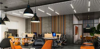 Espaço interno moderno com mesa de reunião e iluminação industrial.