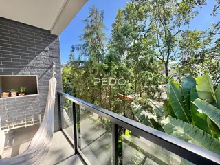 Vista da varanda com vegetação exuberante.