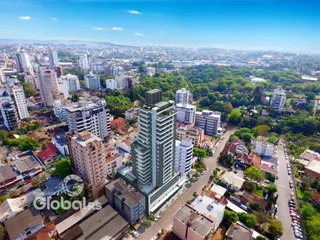 Vista aérea de uma área urbana densa com edifícios e vegetação.