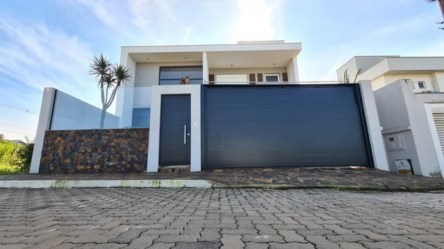 Foto da fachada de uma casa moderna com garagem em Lajeado, Brasil.