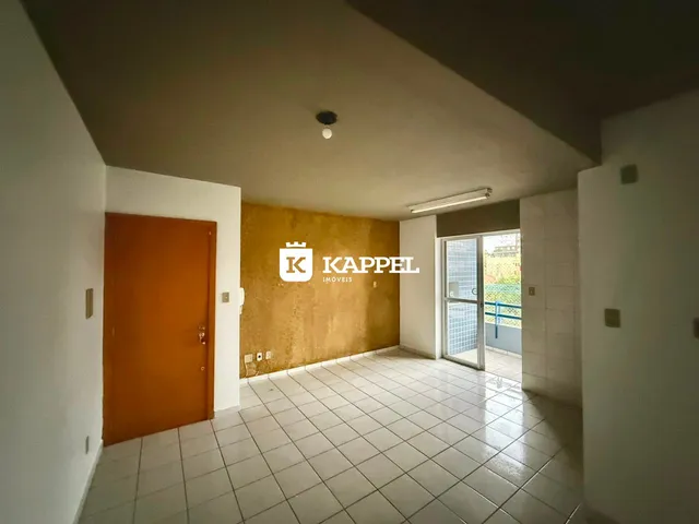 Ambiente interno com piso de cerâmica e parede amarela em um imóvel.