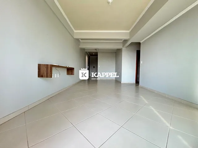 Hall de corredor com piso de cerâmica claro e prateleira de madeira na parede.