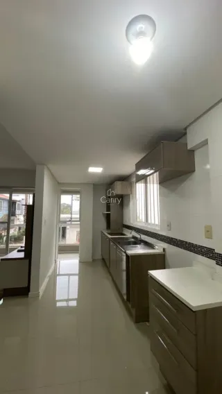 Hall de entrada com paredes brancas e piso claro.