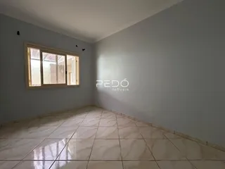 Ambiente interno com piso de cerâmica claro e parede lisa.
