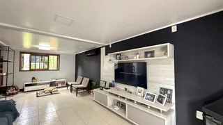 Sala de estar com parede escura e piso de cerâmica.