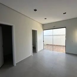 Vista interna de um corredor com paredes brancas e piso claro.