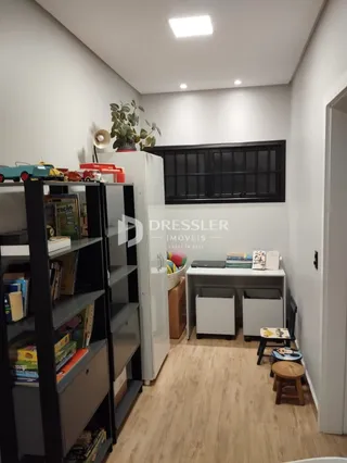 Hall com estantes e armários brancos em um imóvel.