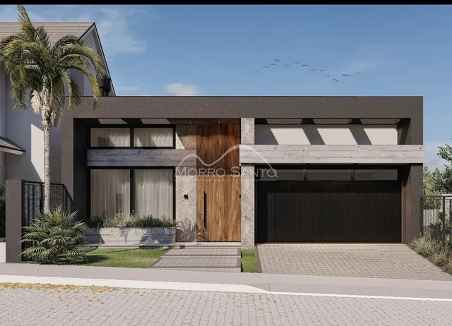 Fachada moderna de uma residência com garagem e paisagismo em Lajeado.