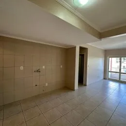 Hall de entrada com piso de cerâmica claro e teto de gesso.