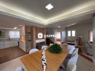 Foto de uma sala de estar e jantar com mesa de madeira e cozinha moderna.