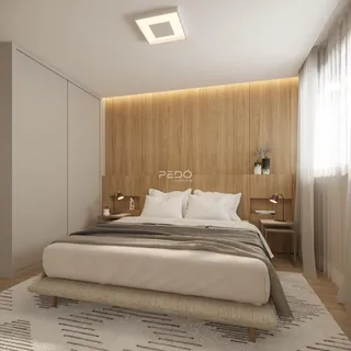 Quarto moderno com cabeceira de madeira e armário branco.