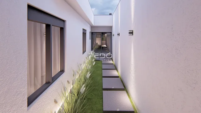 Vista de um corredor interno com jardim estreito.