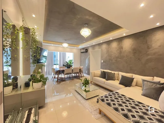 Sala de estar moderna com paredes cinzas e piso claro.