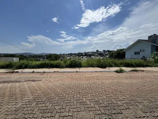 Vista da fachada da propriedade em Lajeado, Brasil, com área pavimentada em primeiro plano.