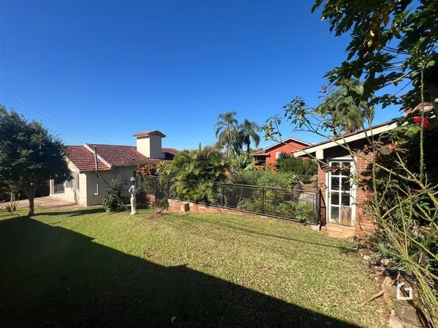 Vista da fachada de uma casa em Lajeado, Brasil, com jardim gramado e cerca.