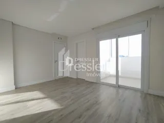 A sala apresenta paredes brancas e piso de madeira clara.