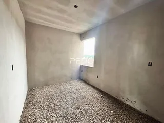 Foto de um cômodo vazio com piso de cascalho em uma residência.