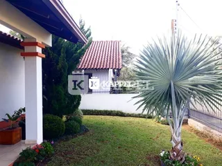 Fachada de uma casa com gramado e palmeira em Lajeado, Brasil.