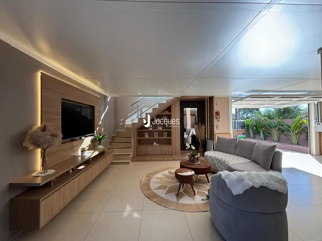 Sala de estar moderna com acabamentos em madeira e decoração contemporânea.