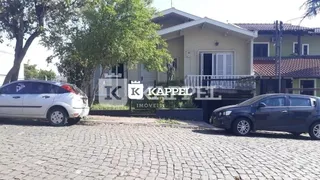 Fachada de uma casa residencial em Lajeado, Brasil, com vegetação ao redor.