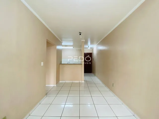 Corredor interno de uma residência com piso de cerâmica branca.