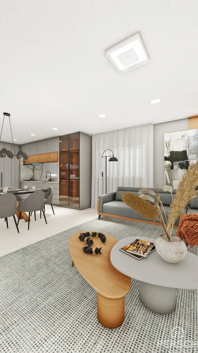 Ambiente interno moderno com cozinha e sala de jantar em um espaço aberto.