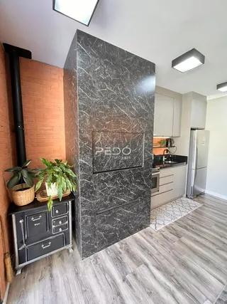 Foto de uma sala de estar com parede de mármore escura.