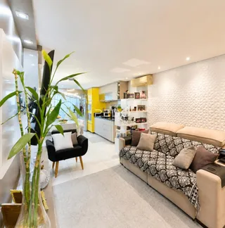 Sala de estar com sofá e cozinha em ambiente moderno.