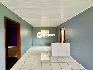 Hall de entrada com piso de cerâmica e parede azul clara.