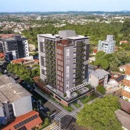 Vista aérea de um edifício residencial em Lajeado, Brasil, cercado por vegetação.