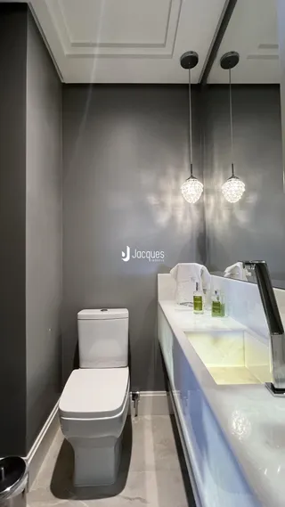 Foto de um banheiro moderno com vaso sanitário e pia.
