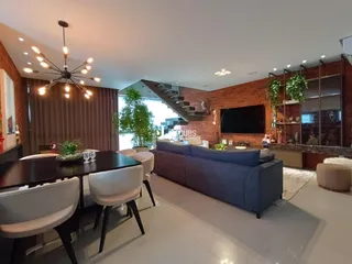 Sala de estar e jantar com decoração moderna em um imóvel no Brasil.