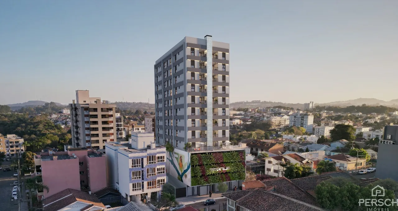 Vista aérea de um edifício residencial em Lajeado, Brasil, com paisagem urbana ao redor.