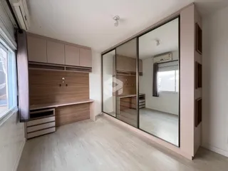 Ambiente interno de uma sala com revestimento de madeira e divisórias de vidro.